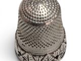 a thimble that is sitting on a white surface