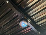 a clock that is hanging from the ceiling of a restaurant