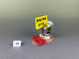 miniature figurine of a man holding a sign with a sign in front of him