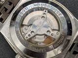a close up of a watch on a black surface
