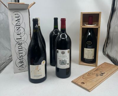 several bottles of wine are lined up on a table next to a bag