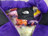 the north face purple and black jacket with purple and yellow print on it