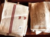 three towels with red and white stripes are on a table