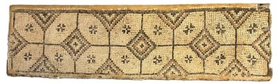 a close up of a woven rug on a white surface