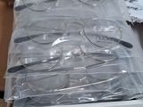 many pairs of glasses in a box on a table