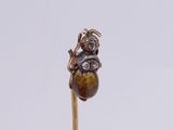 a small brown object on a stick on a white surface
