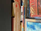 many books that are stacked on top of each other