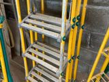 several ladders are stacked on top of each other in a room