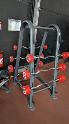 a gym equipment set up in front of a black wall