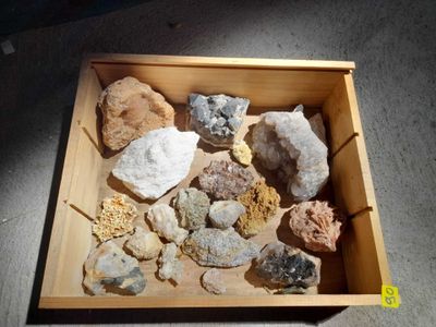 a wooden box filled with different types of rocks