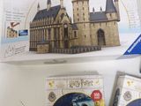 two harry potter puzzles are sitting on a table next to each other