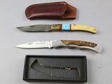 three different types of knives and a case on a table