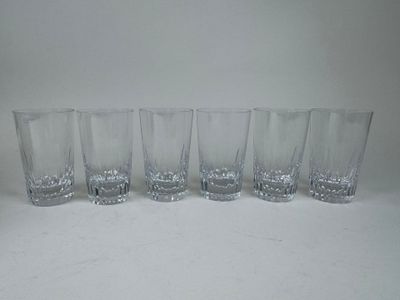 five glasses lined up on a table with a white background