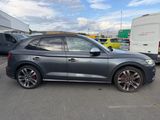 the audi q3 is parked in a parking lot with other cars