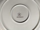 a close up of a white plate with a logo on it