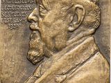 a close up of a bronze plaque of a man with a beard