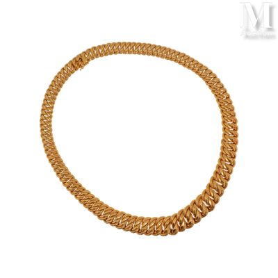 a close up of a gold necklace on a white background