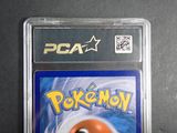 the card is in a clear plastic holder on a black surface