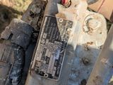 a close up view of a dirty motorcycle with a broken engine