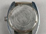 a close up of a watch on a white surface