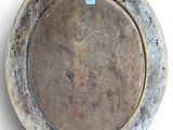an old metal plate with a hole in it