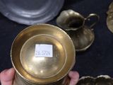 a person holding a gold cup with a sticker on it