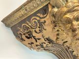 a gold and black clock with a lion head on it