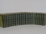 many books stacked on top of each other on a table