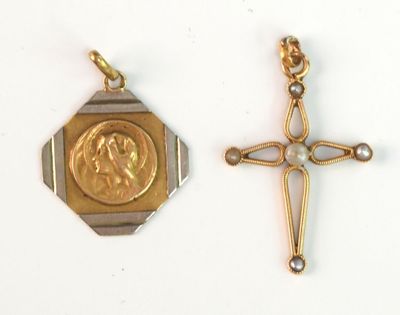 two gold crosses and a gold medal on a white surface