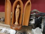 a wooden statue of a person on a table