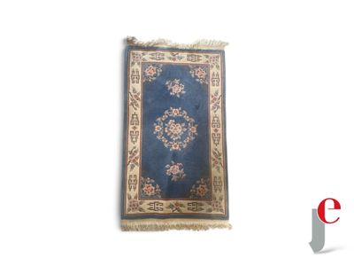 a blue rug on a white background with a red and white logo