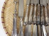 a lot of silverware in a basket on the table