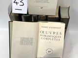 several books are stacked on top of each other on a table