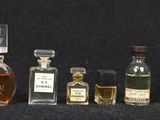 many bottles of different types of perfume on a table