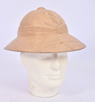 helmet of a man wearing a tan hat on a mannequin head