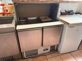 a kitchen with a stove, refrigerator, sink, and refrigerator freezer