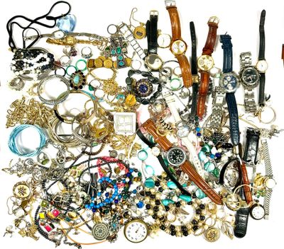 a pile of assorted jewelry on a white surface