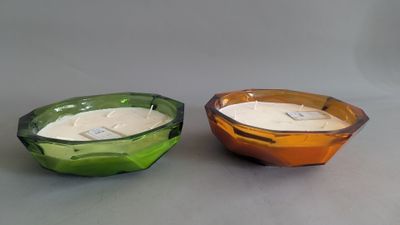 two bowls with a candle inside of them on a table