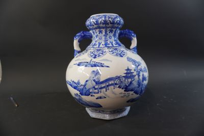 two blue and white vases sitting on a table