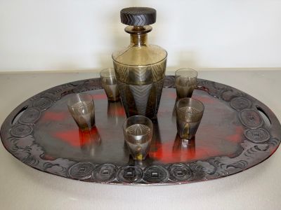 a silver tray with a silver vase and glasses on it