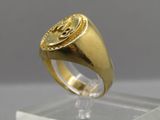 a picture of a gold signet ring on a clear stand