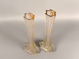 pair of clear glass vases with gold rims on a white surface