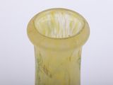 a yellow glass vase with a flower design on it