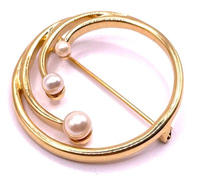 a close up of a brooch with pearls on a white background