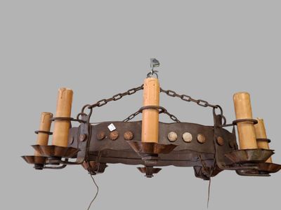 a chandelier made of metal and wood with candles
