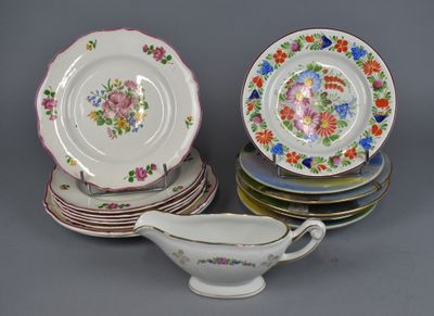 a lot of plates and a gravy dish on the table
