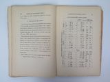 an open book on a white table with a number of numbers