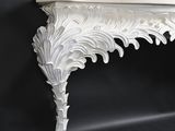 a white shelf with a decorative design on it