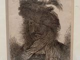 an old picture of a man with a feathered headdress in a white frame