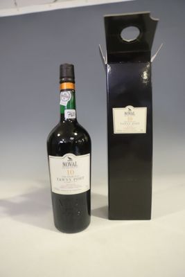a bottle of wine sitting next to a black box